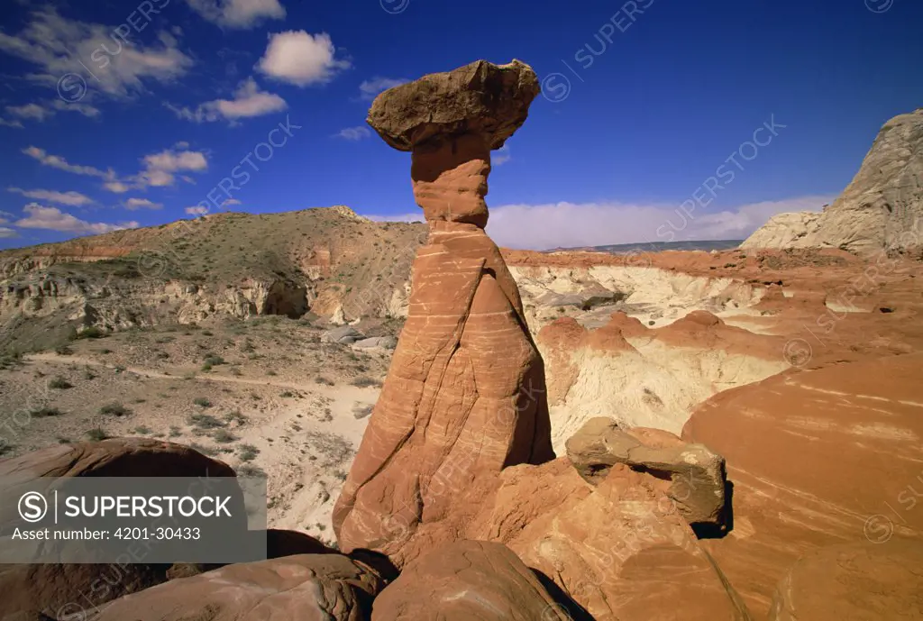 Toadstool Caprocks against petrified sand dunes, cliffs, boulders and hoodoos, near Paria River, Grand Staircase-Escalante National Monument, Utah