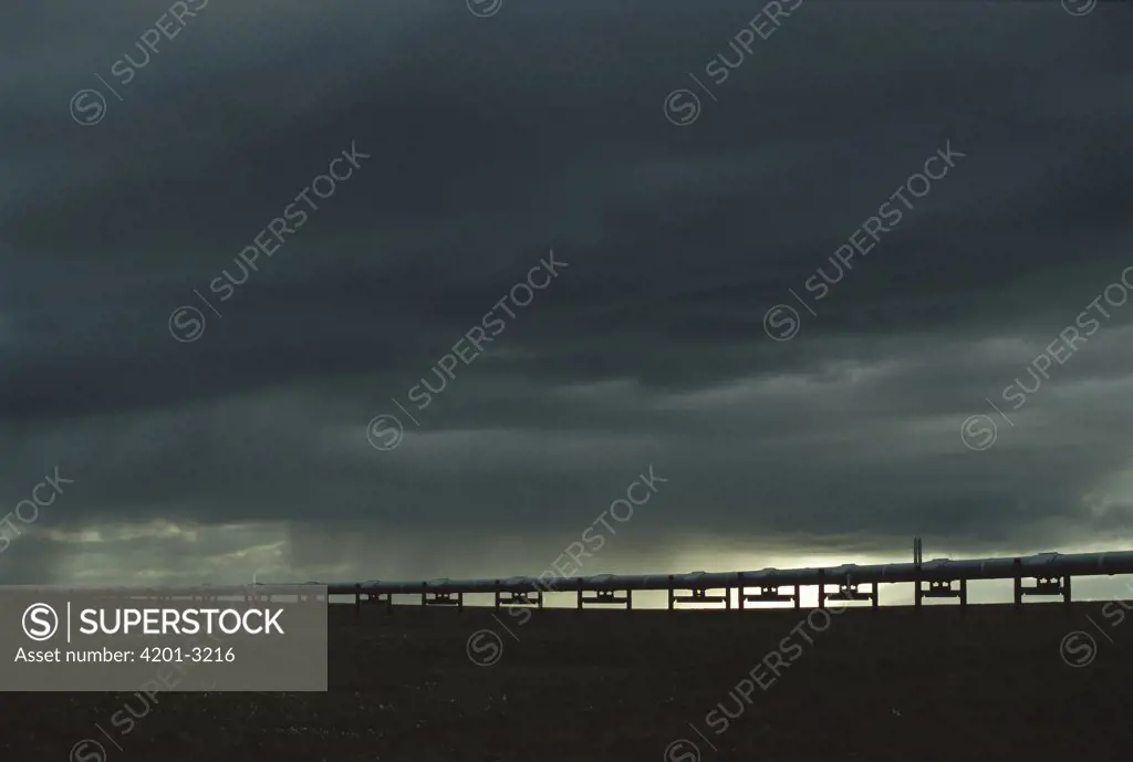 Alaskan oil pipeline against a stormy sky, North Slope, Alaska
