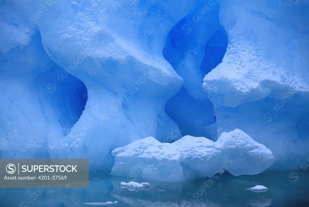 Eroded base of an iceberg in a snowstorm, Pleneau Island, Antarctic Peninsula, Antarctica
