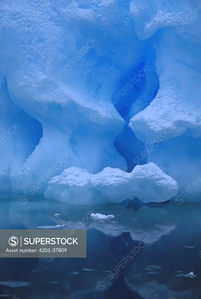 Eroded base of iceberg in snowstorm, Pleneau Island, Antarctic Peninsula, Antarctica