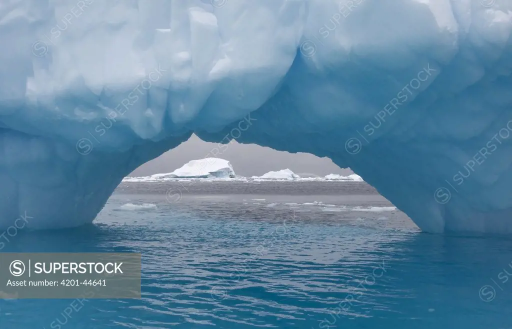 Arched iceberg off the coast, Antarctic Peninsula, Antarctica