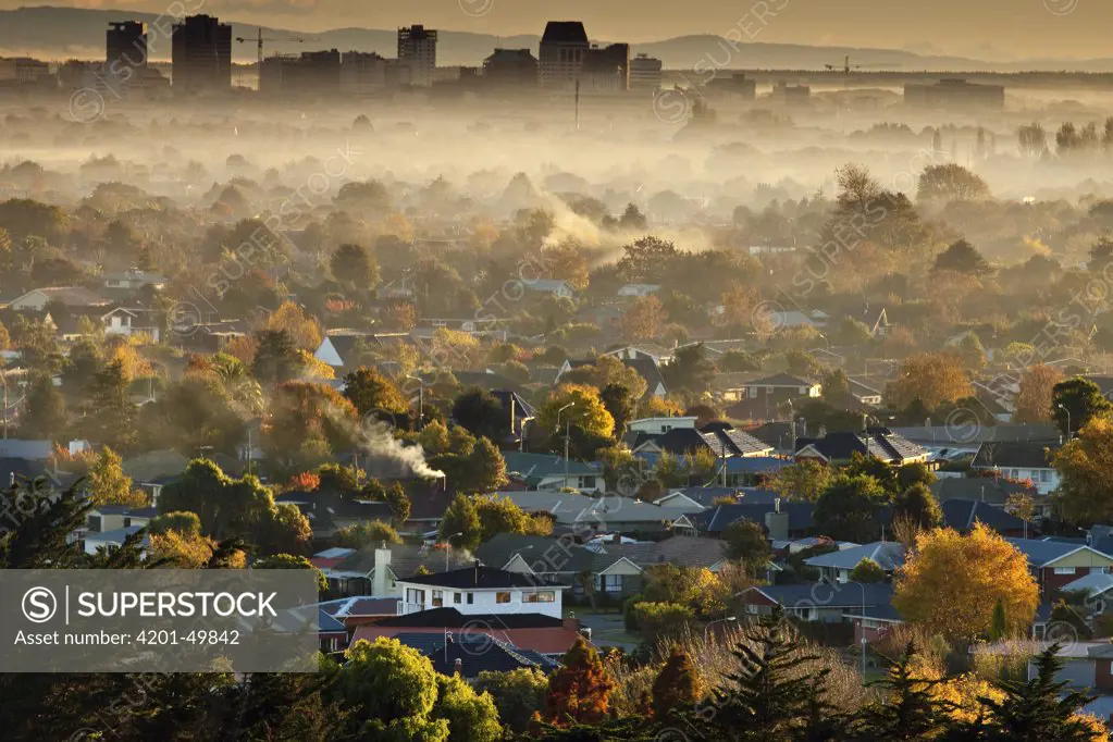 Smog from wood and coal fires blankets suburbs and city center on autumn dawn, Christchurch, Canterbury, New Zealand