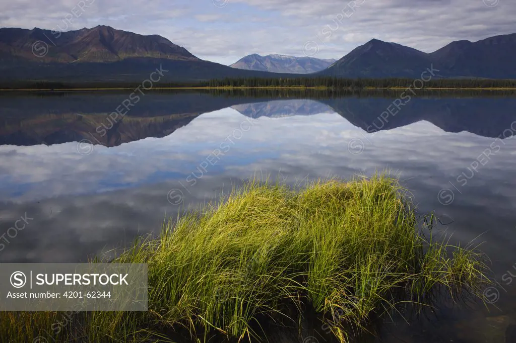 Reflections of mountains in calm lake, Kluane Range in background, Yukon, Canada