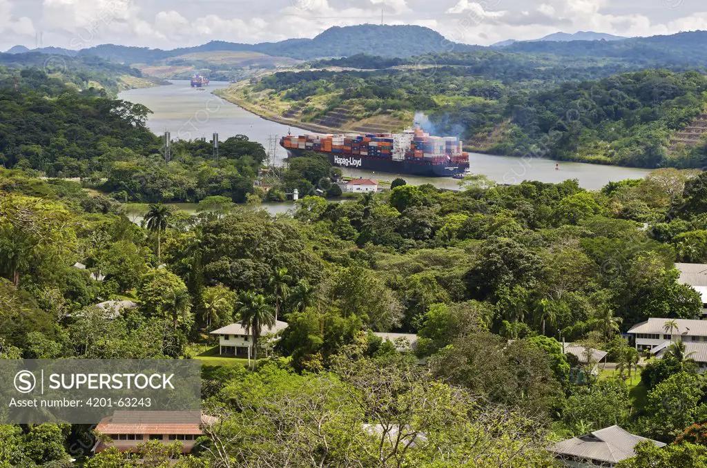 Panama Canal with container ships next to townsite, Gamboa, Panama