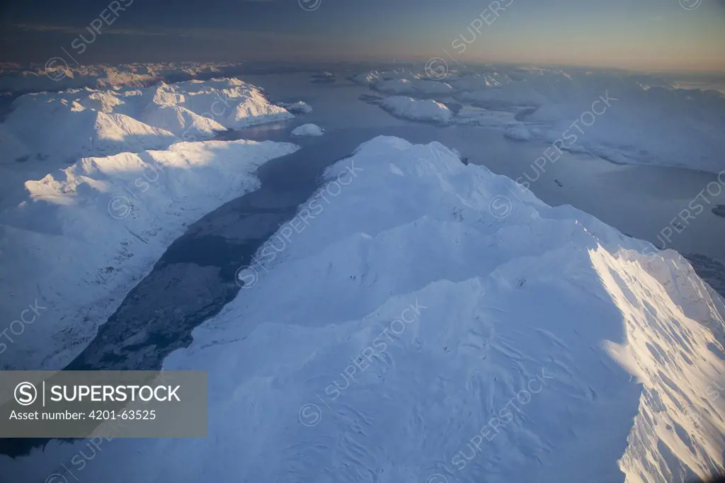 Late afternoon winter sun illuminating Mount Abdallah separating Tarr and Rendu Inlet, Glacier Bay National Park, Alaska