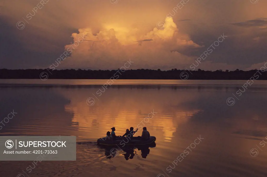 Sunset with people in canoe, Laguna Zancudo Cocha, Ecuador