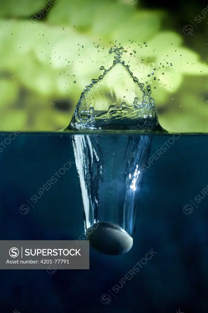 A rock splashing into water. Photographed with a high-speed camera