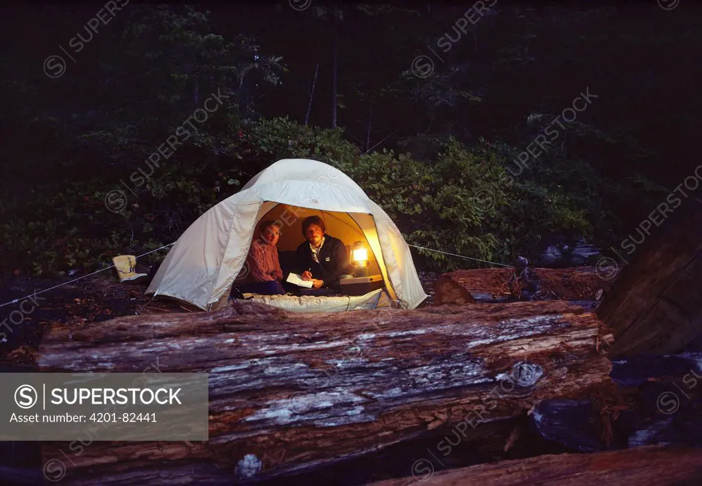 Orca researchers John Ford and Deborah Kavanagh in the field reviewing data in tent, Vancouver Island, British Columbia, Canada