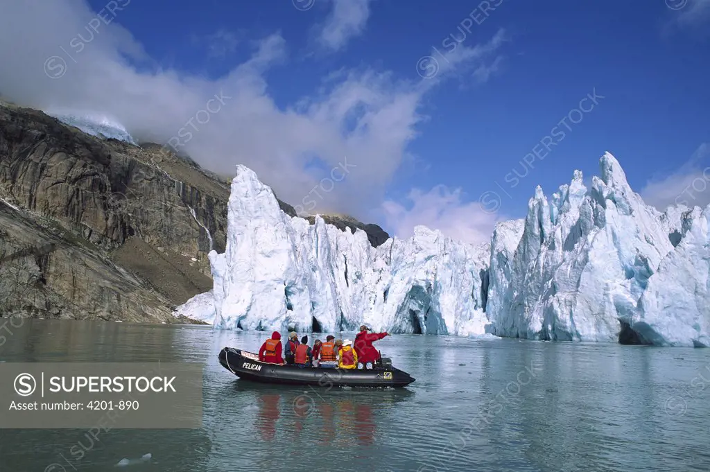 Glacier with tourist expedition in inflatable zodiac, southern Greenland Fjords, Greenland