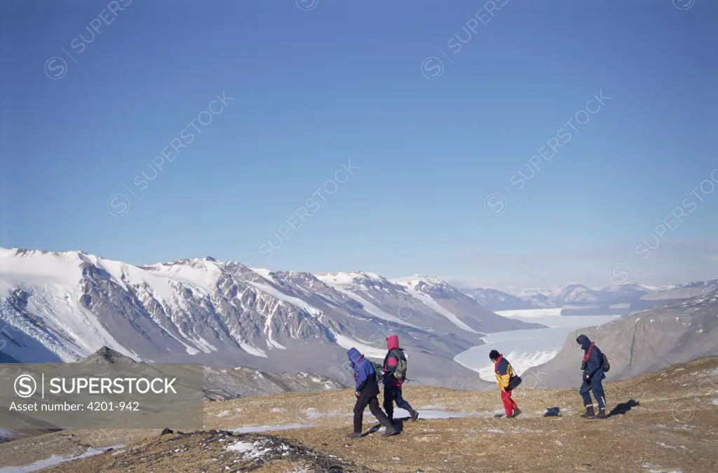Tourists in frozen desert sheltered by Asgard Range, Taylor Dry Valley, Ross Sea, Antarctica