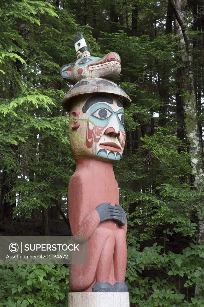 Man Wearing Bear Hat Totem carved by the Tlingit people acts as grave marker, Totem Bight State Historical Park, Ketchikan, Alaska
