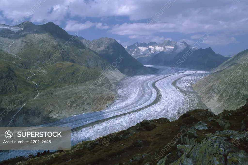 Aletsch Glacier moving through the Swiss Alps showing lateral and medial moraines, Wallis, Switzerland