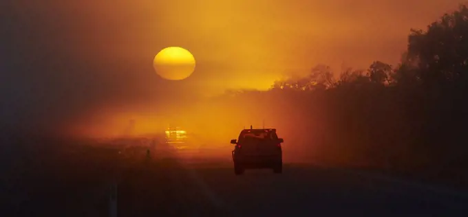 Car driving on road at sunrise, Broome, Kimberley, Western Australia, Australia