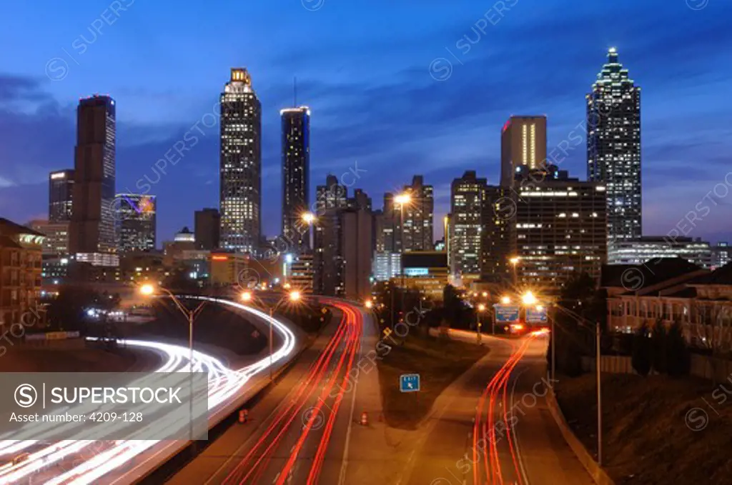 High angle view of traffic with buildings lit up at dusk, Atlanta, Georgia, USA