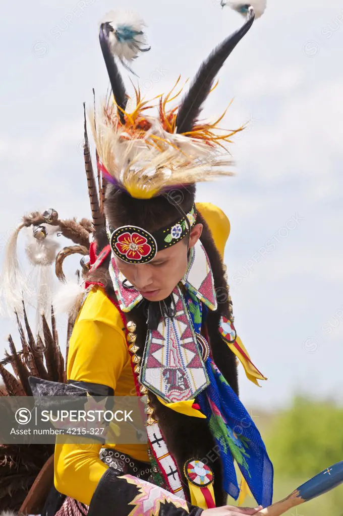 Young male dancer in traditional regalia in 2nd Annual World Chicken Dance Championships, Blackfoot Crossing Historical Park, Alberta, Canada