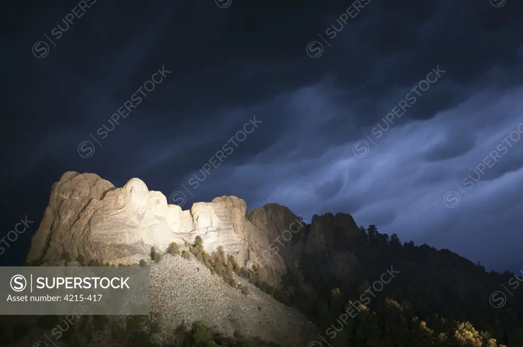 Storm clouds over Mt Rushmore National Monument at night, South Dakota, USA
