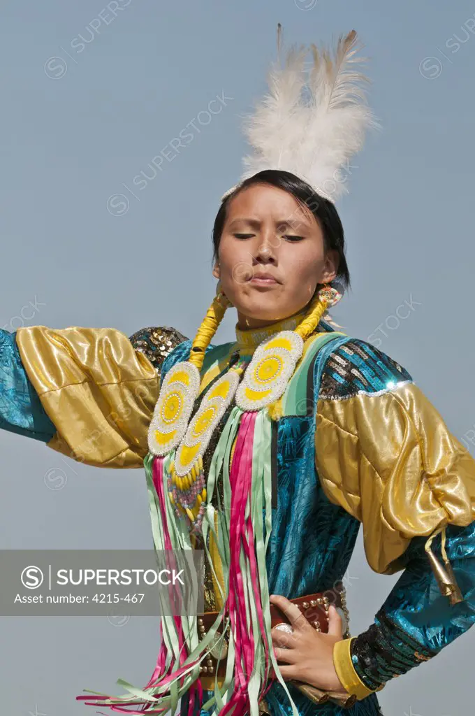 Female dancer in jingle dance regalia at powwow, Blackfoot Crossing Historical Park, Alberta, Canada