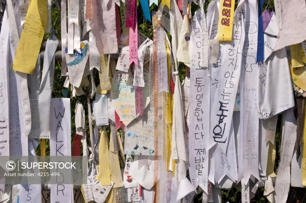 Messages and flags pinned to the fence between North and South Korea within the Demilitarized Zone, Imjingak, South Korea