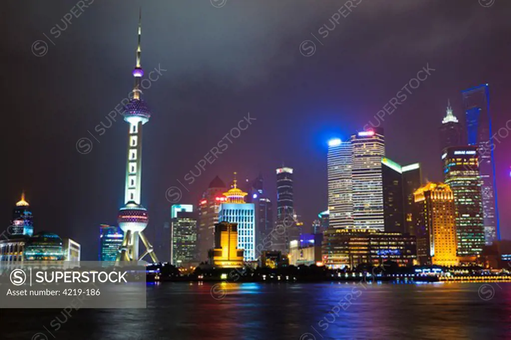 China, Shanghai, Cityscape of Pudong illuminated at night with Oriental Pearl Tower, Jinmao (Jin Mao) Tower and Shanghai World Financial Tower