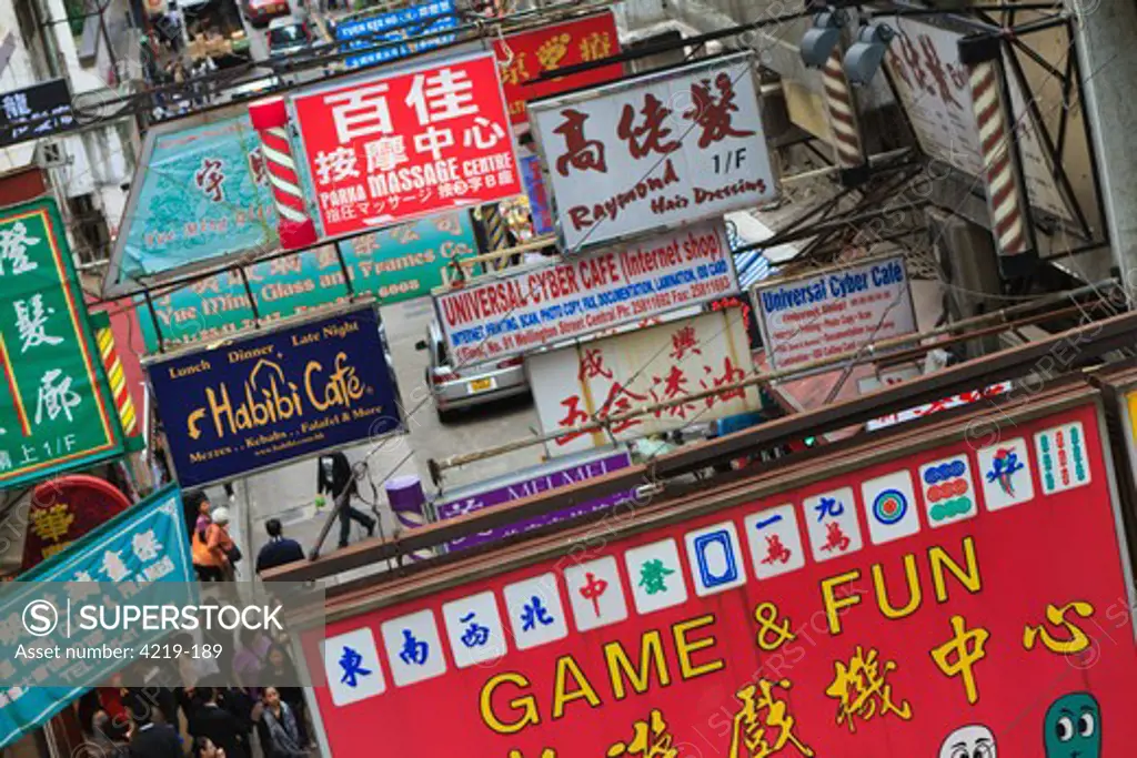 China, Hong Kong, Shop and business signs span road in Mid Levels district