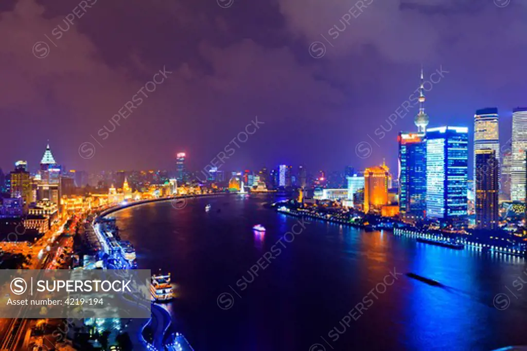 China, Shanghai, Cityscape of Shanghai with Bund, Huangpu River and Pudong illuminated at night with Oriental Pearl Tower