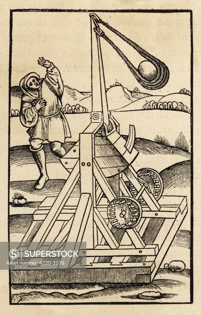 A rather lethal looking  catapult with a huge sling  on a wooden base.