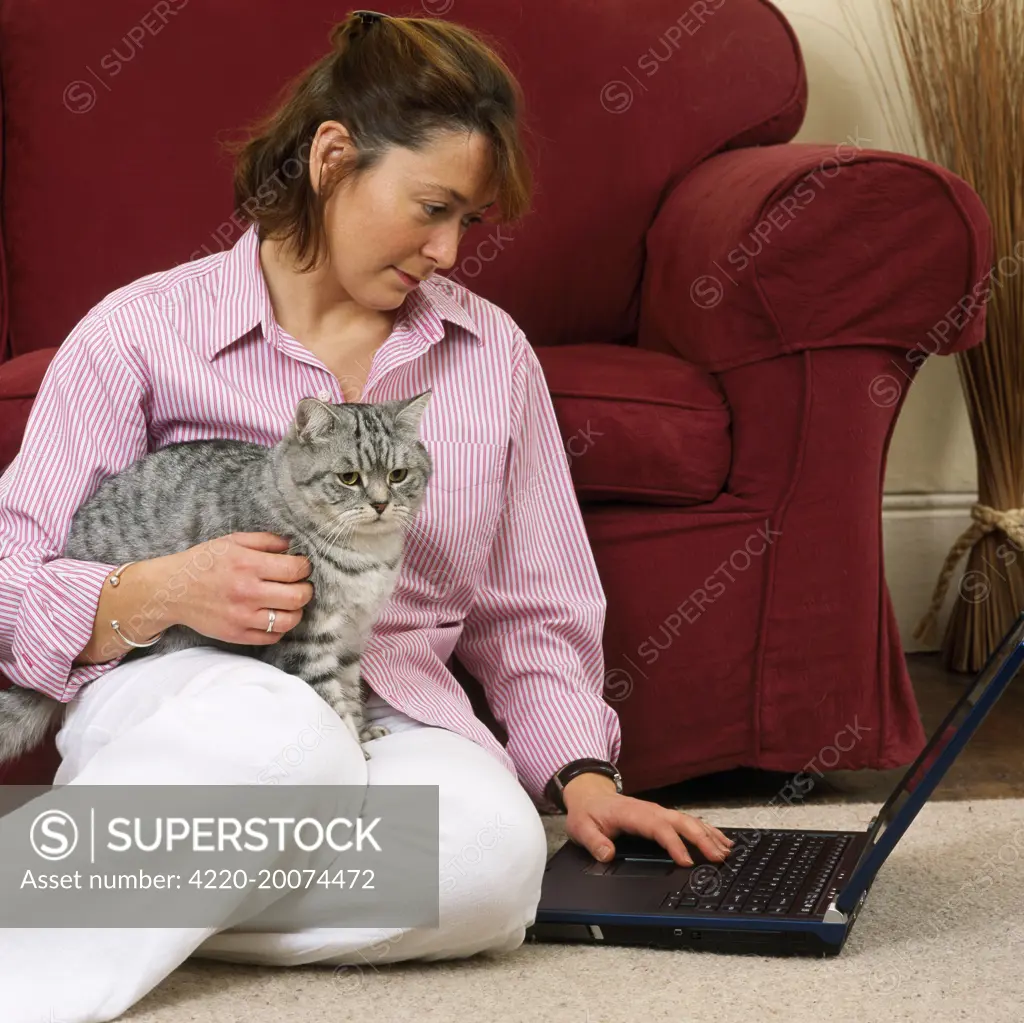 CAT - Girl with silver tabby cat, in contemporary setting 