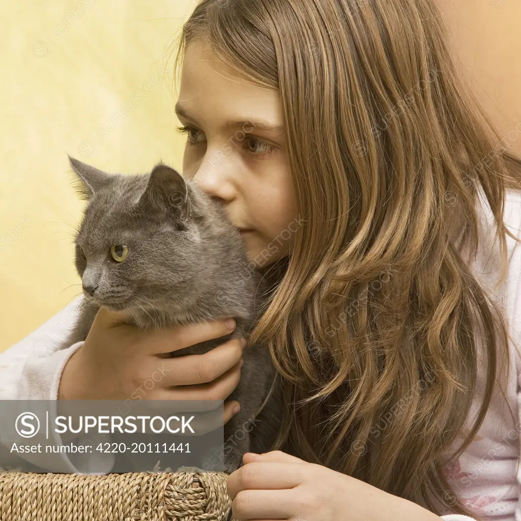 Girl - cuddling grey cat 