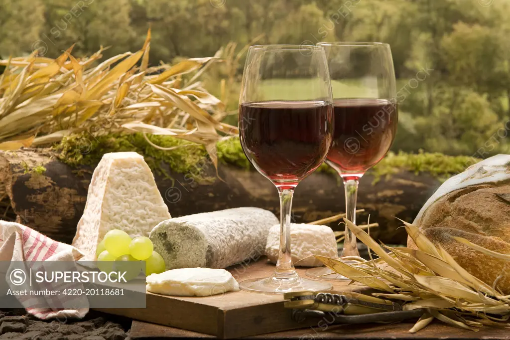 Table - with two glasses of red wine with cheese &amp; bread 