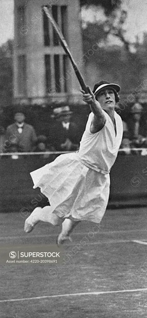 Miss E. Colyer makes one of her famous leaps across the court.     Date: 4th July 1925