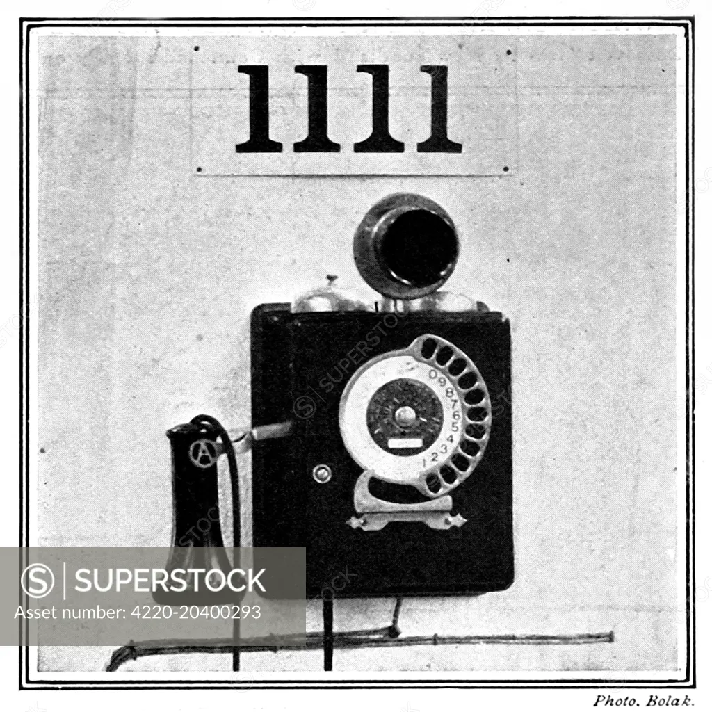 Photograph of the first automatic telephone exchange system (modern telephone), installed by the German Post Office in 1909.  The original caption explained: 'Each subscriber is his own exchange, moving the clocklike face of the telephone until the right sequence of numbers has been called.'     Date: 1909