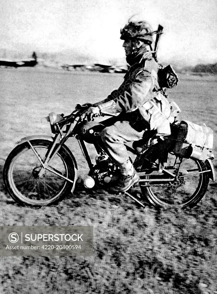 Photograph showing a soldier, of the Motorcycle Section of the British First Airborne Division, heading off on his motorcycle, 1944.    The lightweight machine shown had a two-stroke petrol engine, was geared for rough surfaces and was light enough to be carried over obstacles.    In September 1944, the British First Airborne Division took part in Operation 'Market Garden'.     Date: 1944
