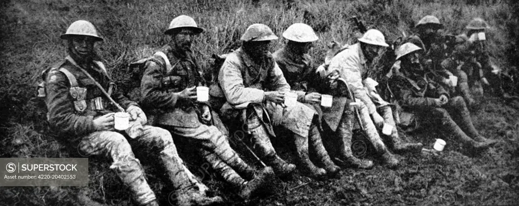 Photograph showing a group of British soldiers, having a rest and a cup of tea after leaving the front line of trenches; Western Front somewhere in France, 1916.     Date: 1916