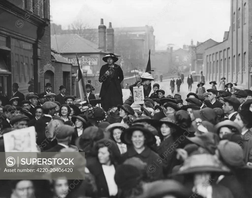 A suffragette addressing a crowd in Reading during the election of 1913.     Date: 1913