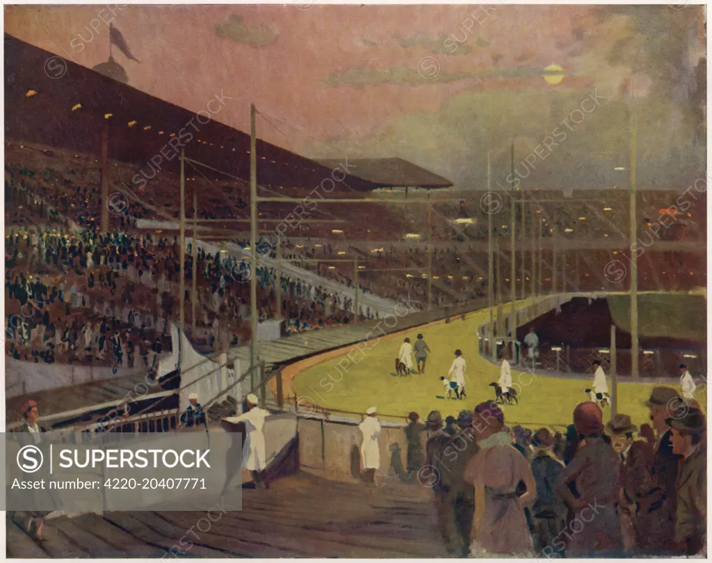 The illuminated track of the greyhound racing stadium at Wembley painted by Algernon Talmage, with the thousands of spectators visible in the stands.      Date: 1933