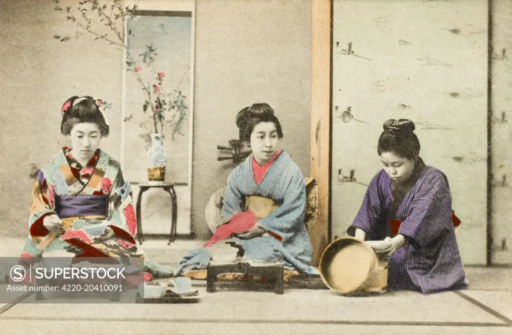 Three Geisha Girls eating a meal. The firl on the right is serving rice     Date: circa 1910