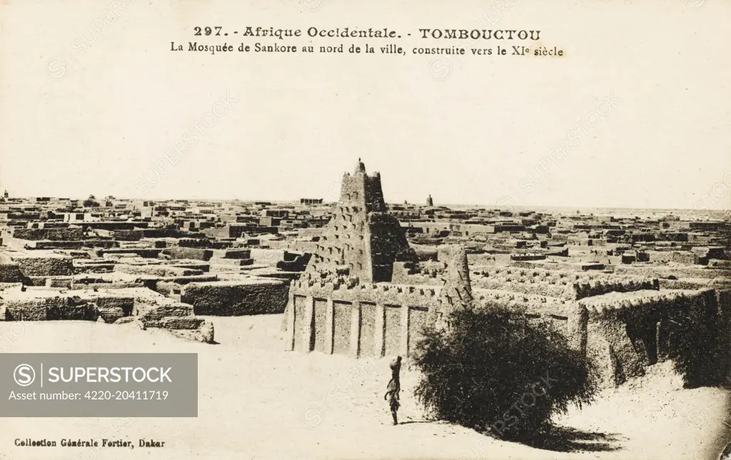 Timbuktu, Mali - the Sankore Mosque (constructed c.11th century) can be seen rising about the mudbrick rooftops in the North of the city.     Date: 1920s
