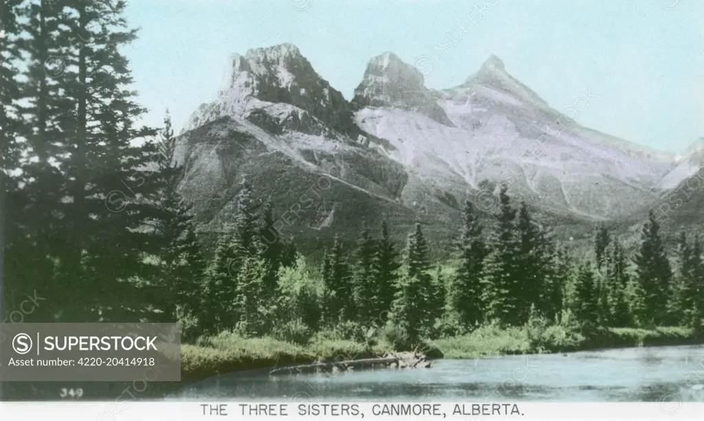 Canada - The Three Sisters, Canmore, Alberta. Called 'Big', 'Middle' and 'Little' sister! - the Bow River is pictures flowing below.     Date: circa 1920s