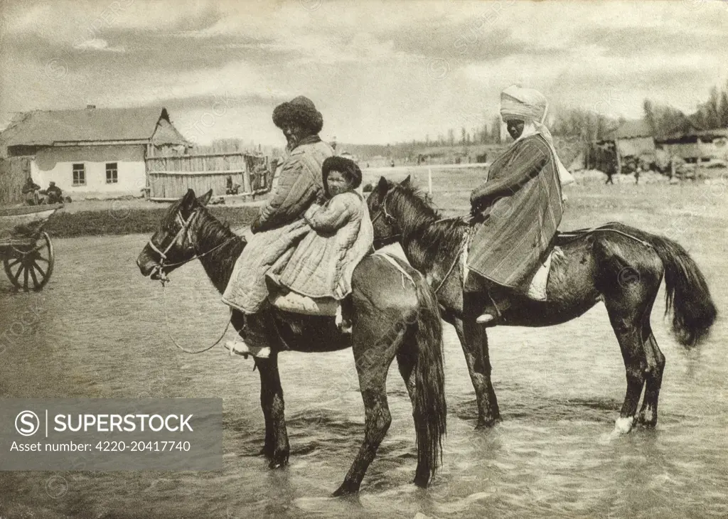 Kyrgyz People - Kyrgyzstan. Both Mother and Father ride ponies and their small child holds on tight behind the Father.     Date: circa 1930s