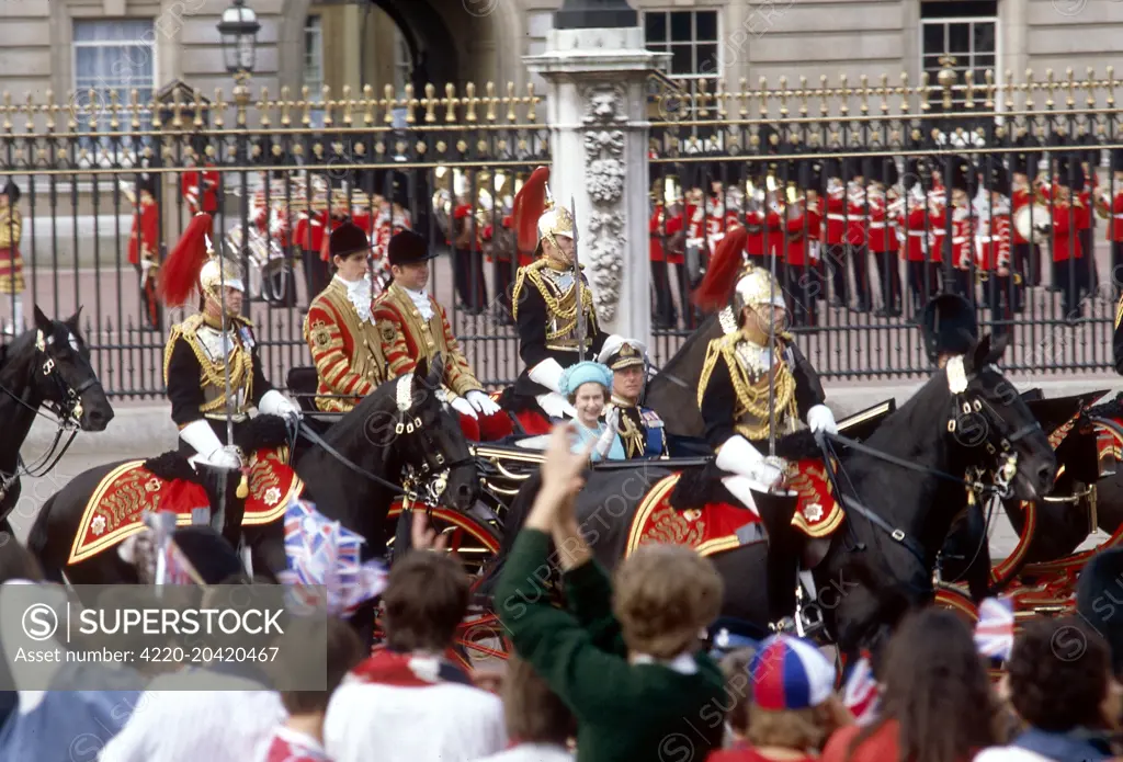 Crowds lining the route from Buckingham Palace to St Paul's Cathedral on the day of the Royal Wedding between Prince Charles and Lady Diana Spencer on 29 July 1981, cheer the Queen and Prince Philip as they pass in a carriage.     Date: 1981