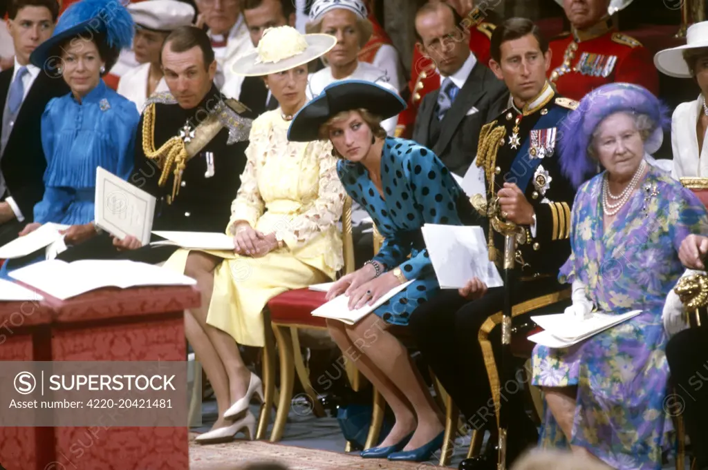 Diana, Princess of Wales leans further forward in her seat than the other members of the royal family in order to catch a glimpse of the approaching bride, Lady Sarah Ferguson who married Prince Andrew, Duke of York at Westminster Abbey on 23 July 1986.     Date: 1986