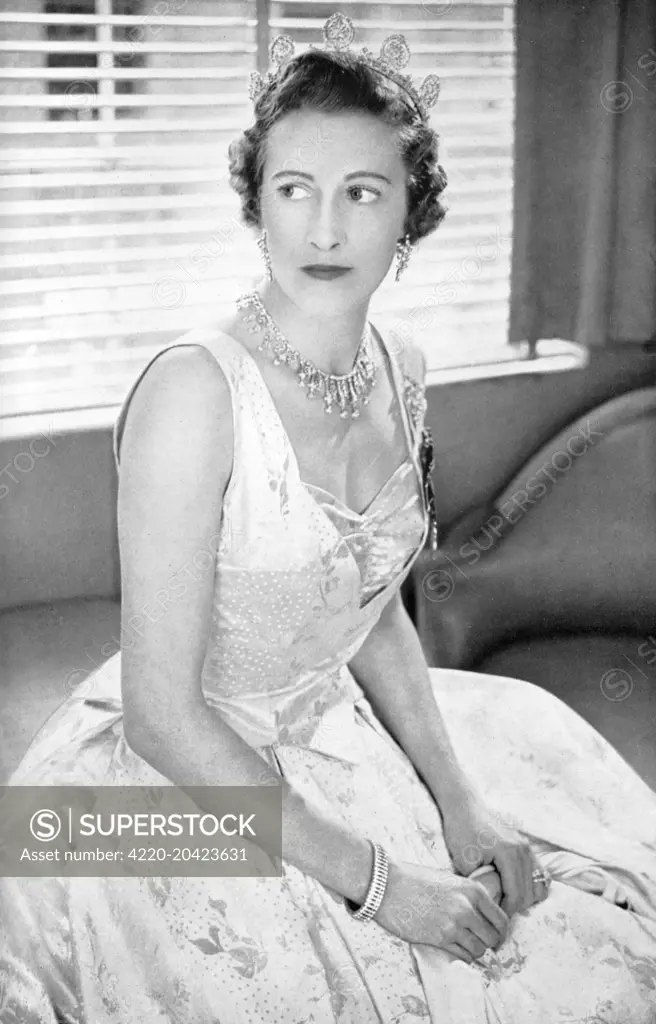 The Countess of Leicester, previously Lady Elizabeth Yorke (1912 - 1985), who acted as Lady of the Bedchamber to Queen Elizabeth II at her Coronation, pictured wearing the Norman Hartnell dress she wore on the occasion.  Designed by Norman Hartnell, it was of a white and gold French lame with a trailing leaf design.     Date: 1953