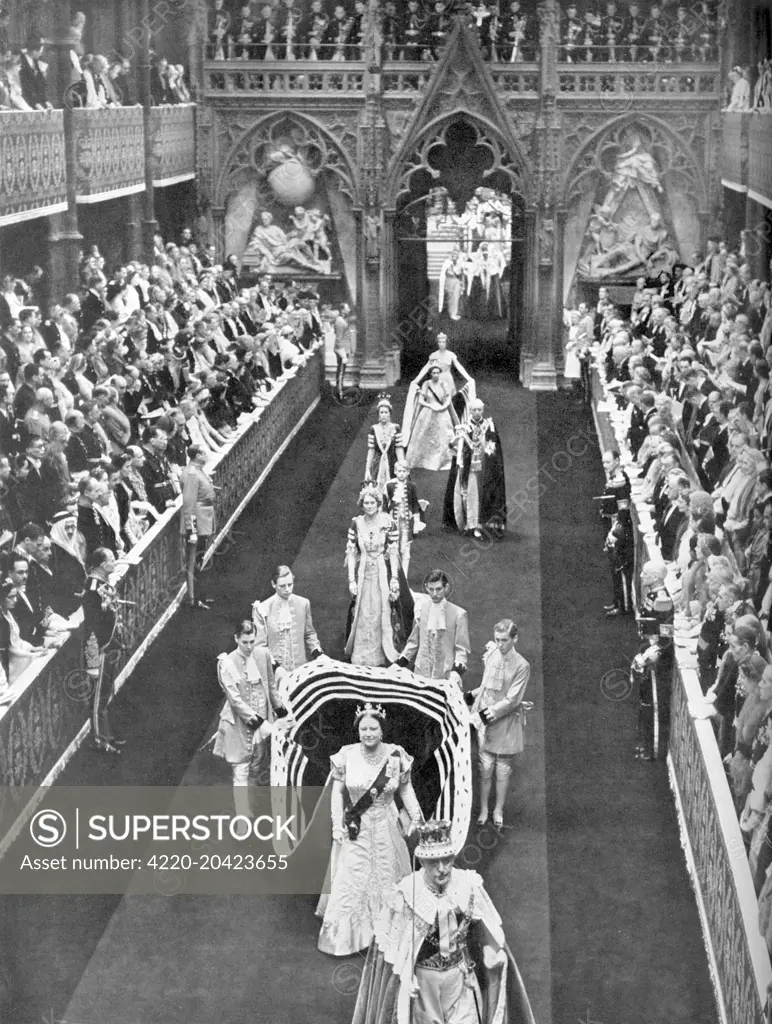 Queen Elizabeth, the Queen Mother passes along the nave of Westminster Abbey en route from the Annexe for the Coronation of her daughter, Queen Elizabeth II in June 1953.  She is followed by Princess Margaret and her retinue.     Date: 1953
