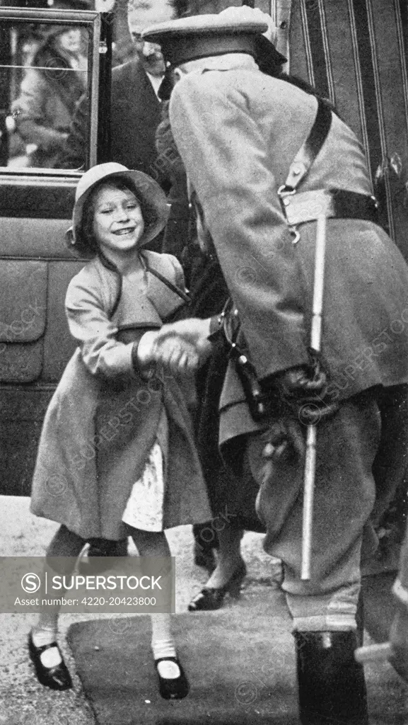 Princess Elizabeth is seen being greeted on her arrival at the daylight rehearsal of the Aldershot Tattoo, at which 50,000 school children were present.   1935