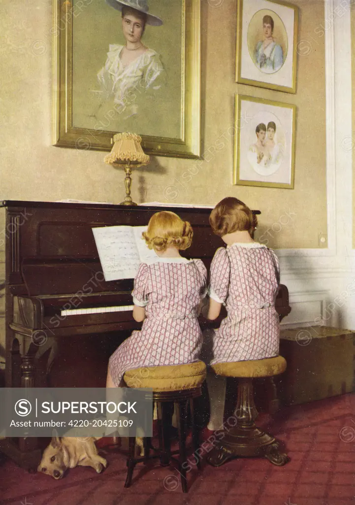 The Princesses, Elizabeth (later Queen Elizabeth II) and Margaret, playing the piano at Windsor Castle in 1940.      Date: 1940