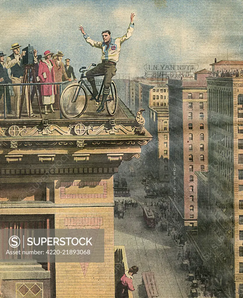  Hollywood stuntman Buddie  Mason cycles along the cornice  of a high-rise building in Los  Angeles, California.      Date: 1925