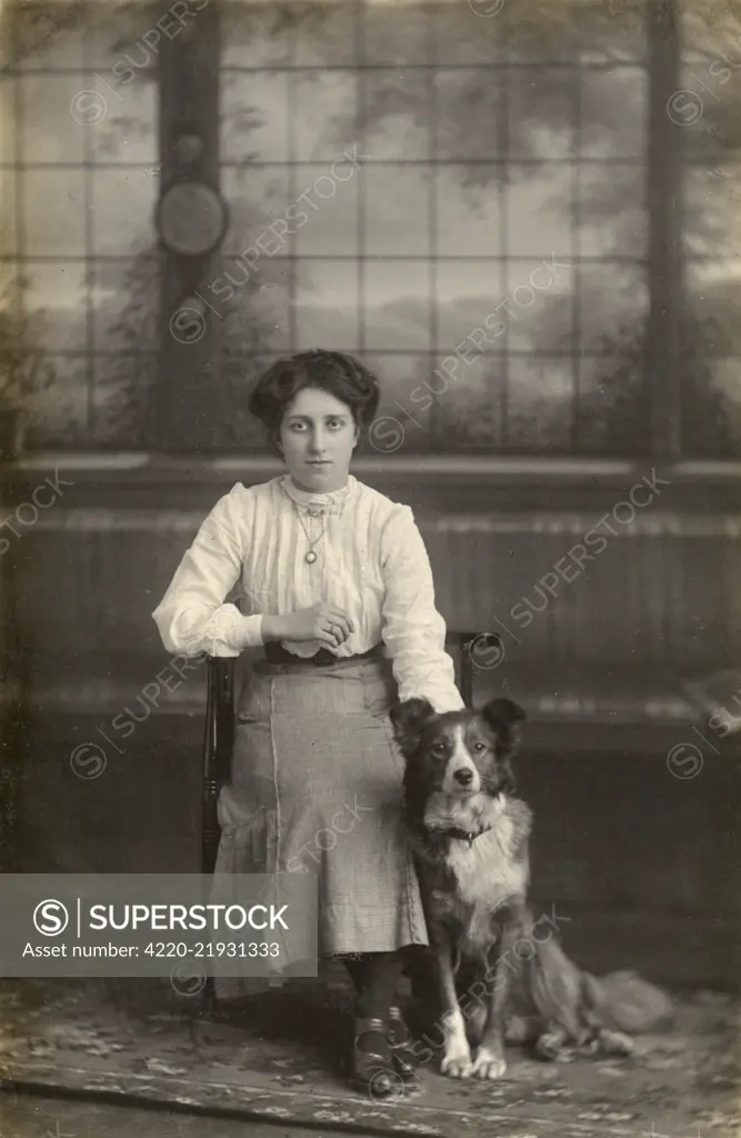 Studio portrait, young woman with dog, photo by J J Payne of Hull, Grimsby and Barnsley.      Date: circa 1920s