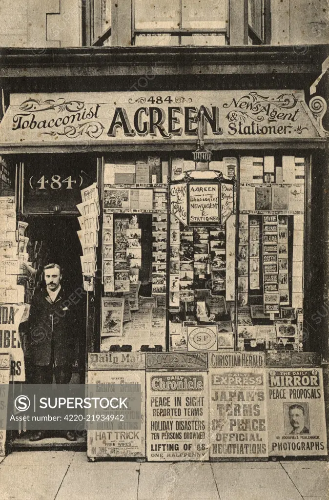 A. Green, tobacconist, newsagent and stationer, 1905. Newspaper boards outside the shop proclaim headlines about peace in the Russo-Japanese war of 1904-05. The newsagent stands in the doorway. Unknown location in Britain.     Date: 1905