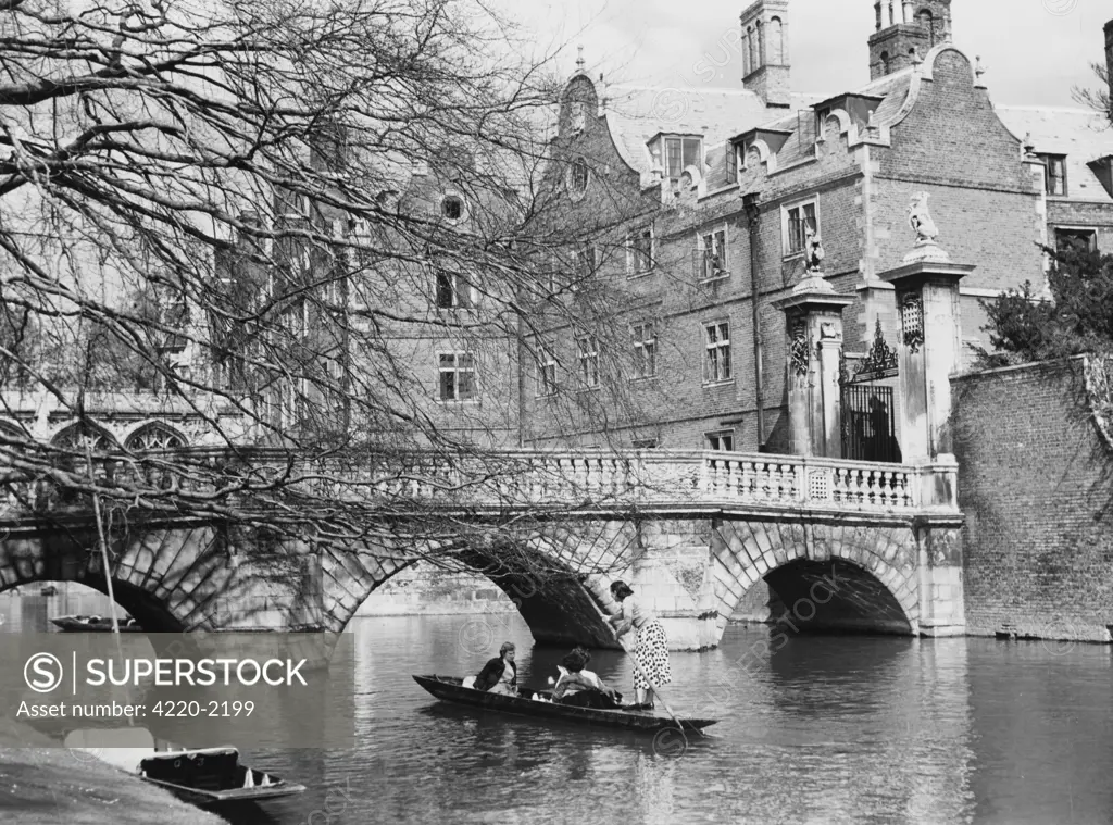 A lady punter takes herpassengers beneath the bridgeover the Cam at St John'sCollege, Cambridge. Date: 1954