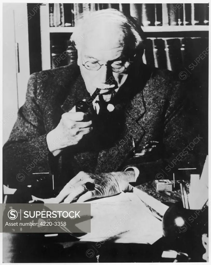 CARL GUSTAV JUNG  Swiss psychologist at his desk       Date: 1875 - 1961